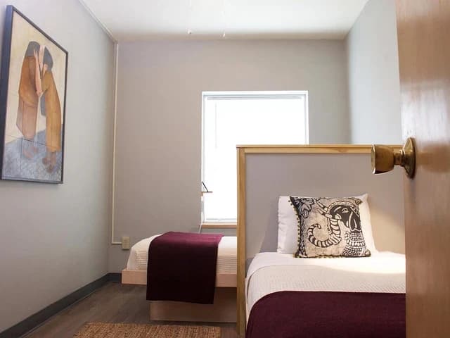 A shared standard room with two twin beds and a window